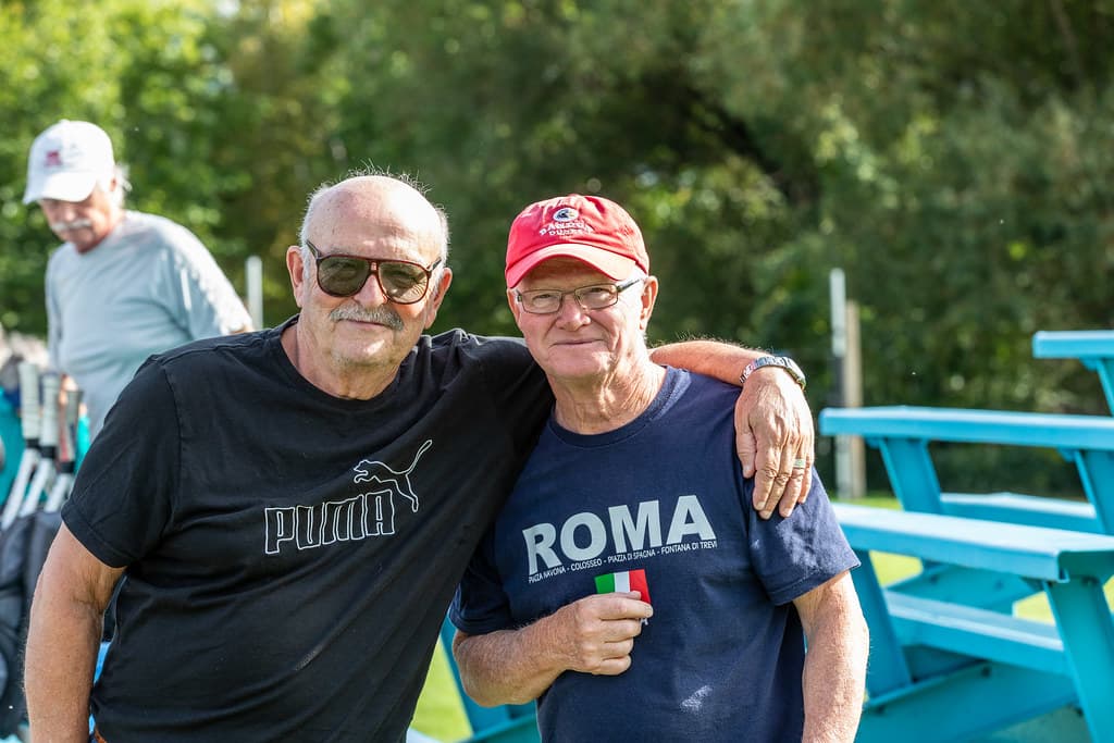 Two players arm in arm after a camp morning