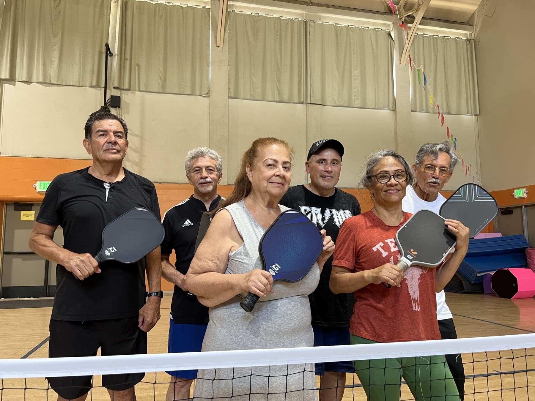 A coach working with a small group at the net