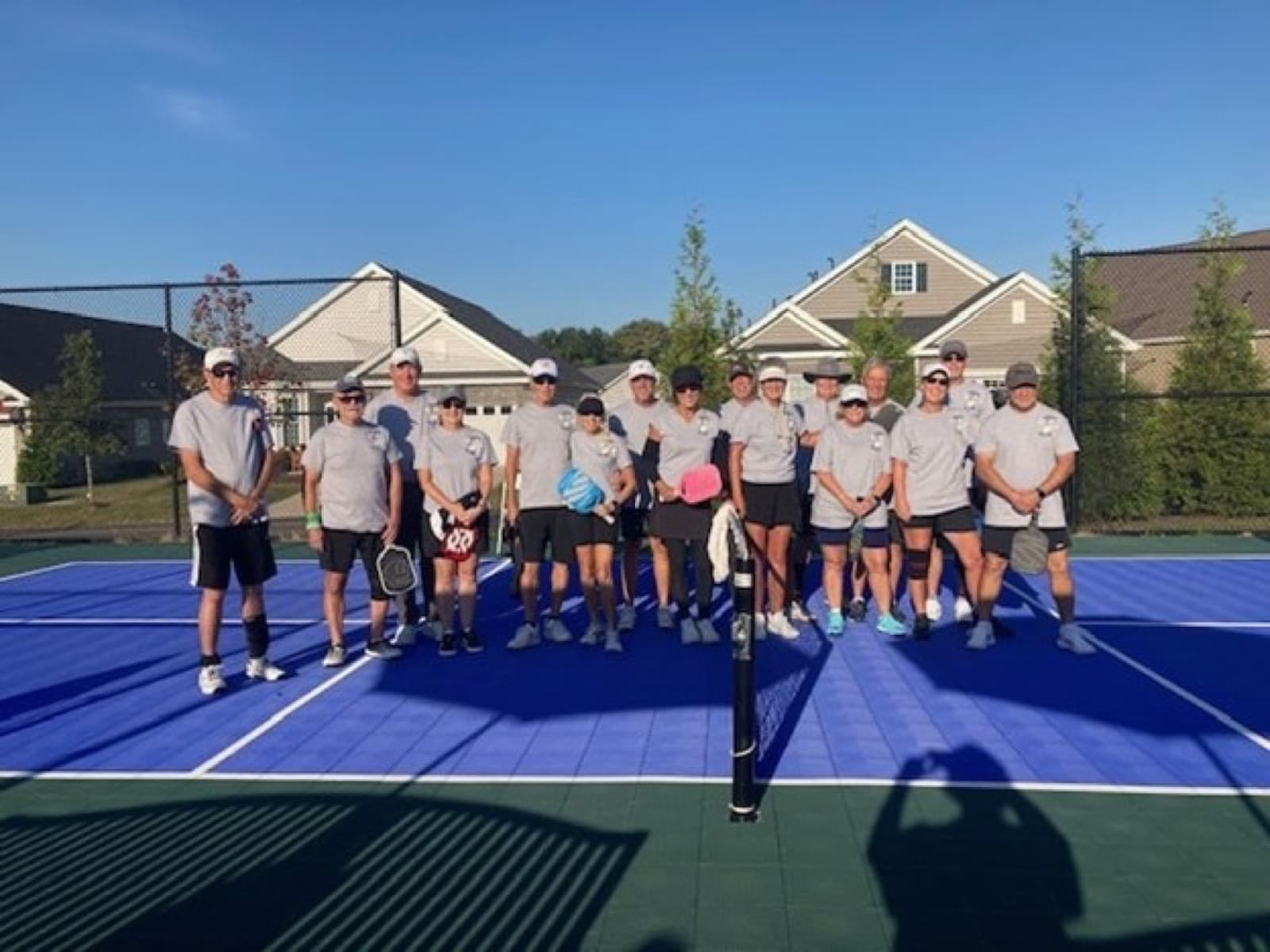 A beginner group lined up on court after a session